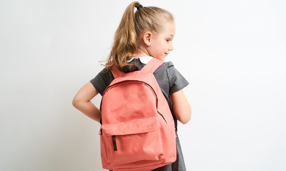 little girl photographed against white background